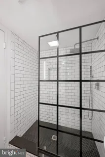 a bathroom with a glass shower door