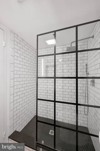 a bathroom with a glass shower door