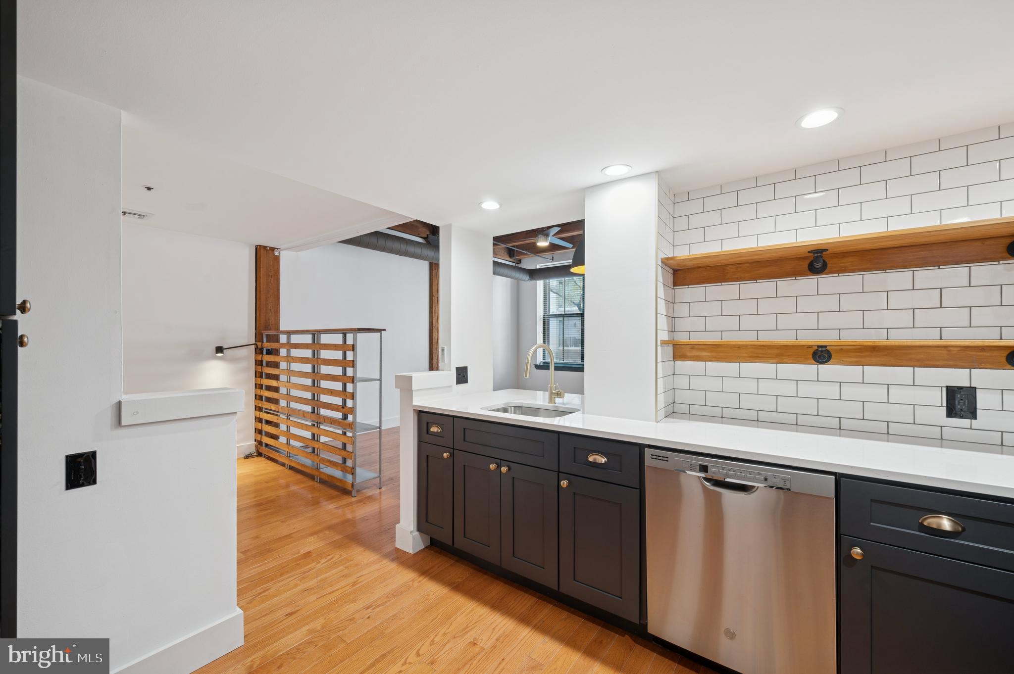 301 Race Street, Unit 308 Philadelphia, PA 19106 - Photo 5 of 17 a kitchen with stainless steel appliances granite countertop a sink and wooden cabinets