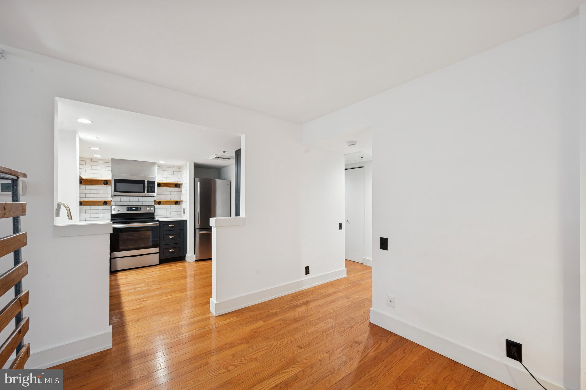 301 Race Street, Unit 308 Philadelphia, PA 19106 - Photo 7 of 17 a view of a kitchen with wooden floor and electronic appliances