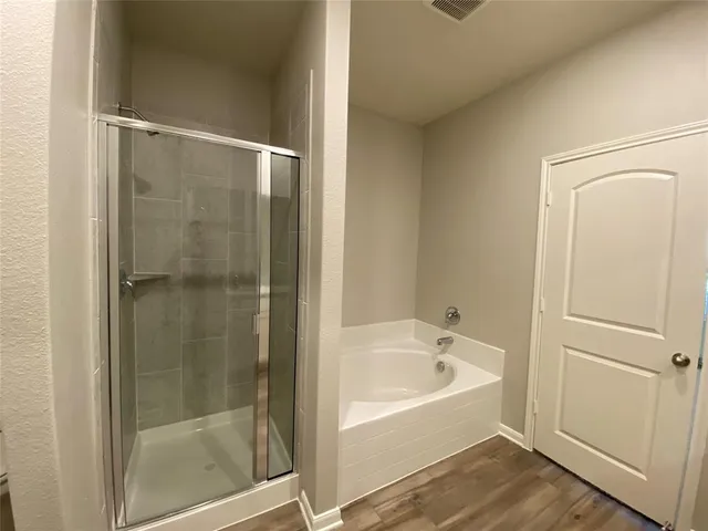 a view of an empty room and a ceiling fan