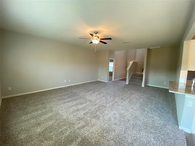 an empty room with a fireplace and fan
