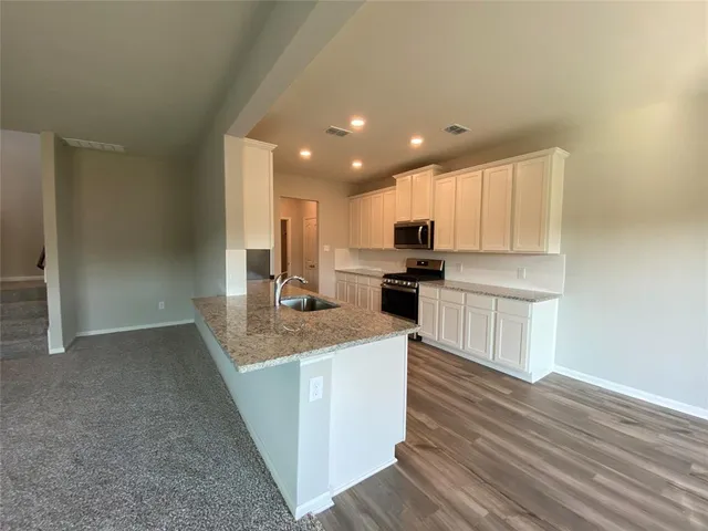 a view of kitchen with wooden floor
