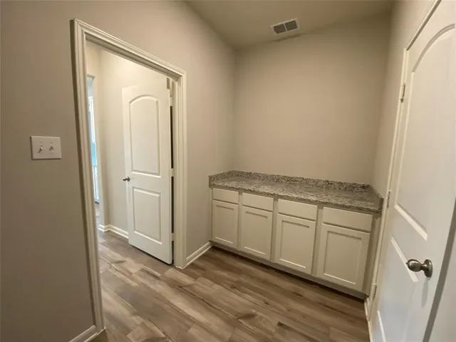 a view of kitchen and wooden floor