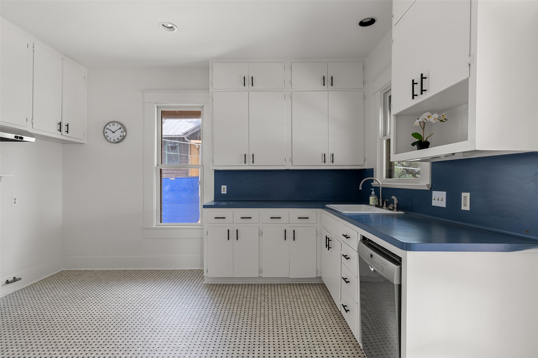 613 Baylor Street Austin, TX 78703 - Photo 15 of 40 a kitchen with granite countertop white cabinets and sink
