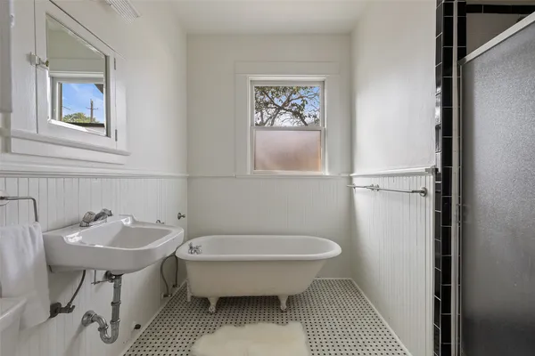 a bathroom with a sink toilet and a mirror
