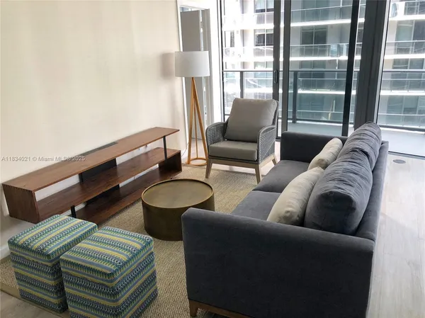 a living room with furniture and a large window