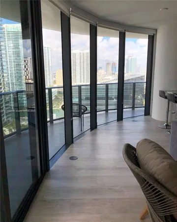 a lobby with furniture and floor to ceiling window