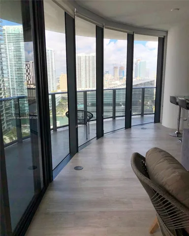 a lobby with furniture and floor to ceiling window