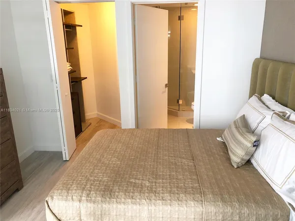 a bedroom with a bed and a mirror