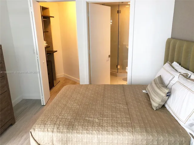 a bedroom with a bed and a mirror