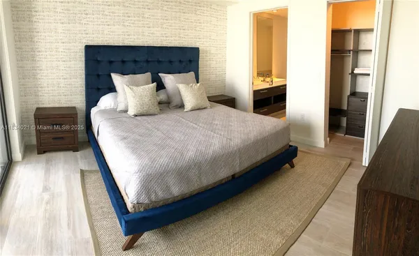 a bedroom with a bed and a couch