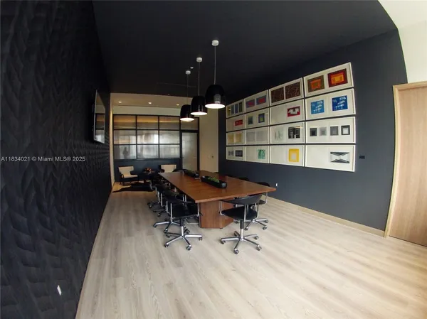 a view of a workspace with furniture and a potted plant