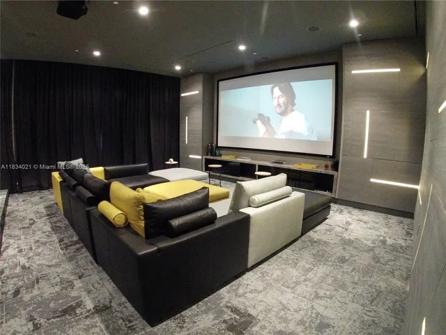 a living room with furniture a rug and a projector