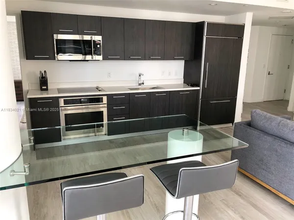 a kitchen with stainless steel appliances and wood cabinets