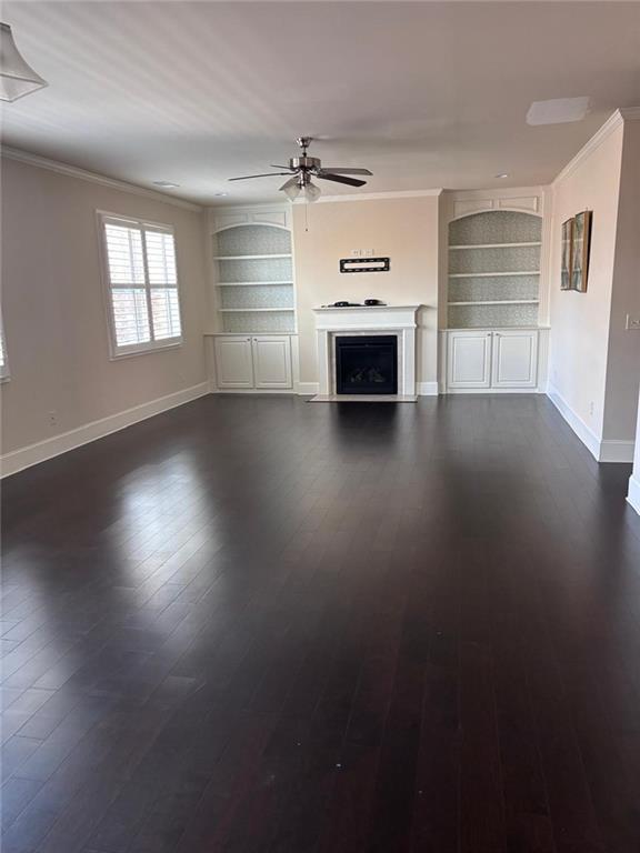 1615 Beckham Street Cumming, GA 30041 - Photo 11 of 33 a view of empty room with wooden floor and fireplace