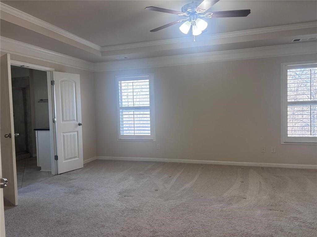 1615 Beckham Street Cumming, GA 30041 - Photo 13 of 33 an empty room with chandelier fan and windows