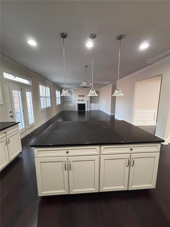 1615 Beckham Street Cumming, GA 30041 - Photo 23 of 33 a kitchen with kitchen island granite countertop a sink a counter space and cabinets