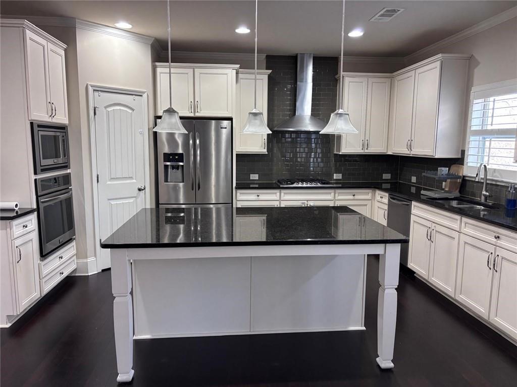 1615 Beckham Street Cumming, GA 30041 - Photo 24 of 33 a kitchen with stainless steel appliances granite countertop a refrigerator a stove and a sink with wooden floor