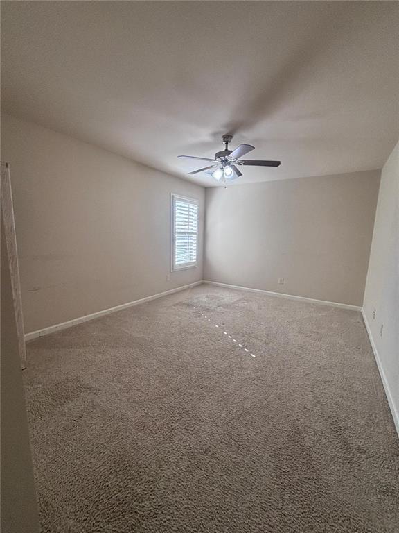 1615 Beckham Street Cumming, GA 30041 - Photo 28 of 33 a view of an empty room with a chandelier fan