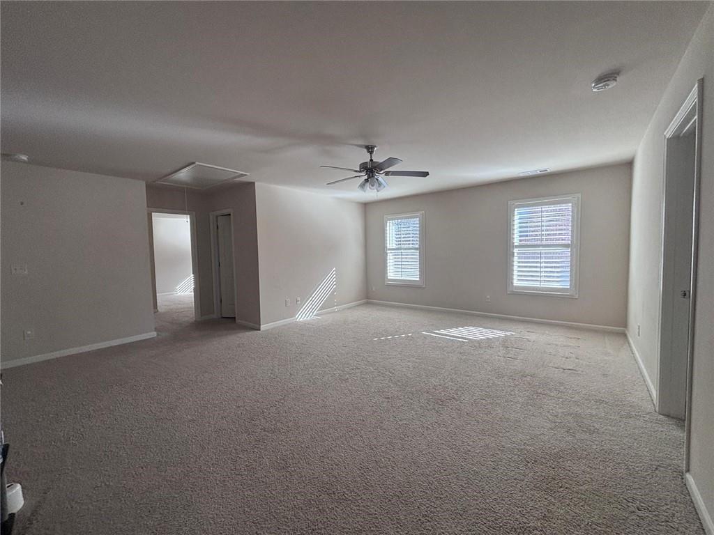 1615 Beckham Street Cumming, GA 30041 - Photo 29 of 33 a view of a big room with windows and chandelier fan