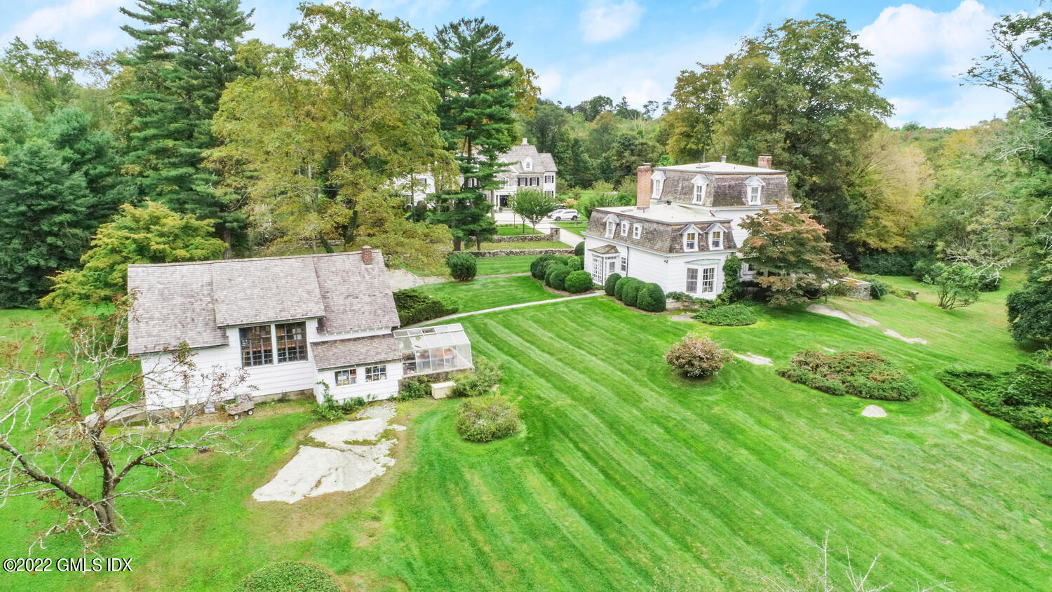 155 Taconic Road Greenwich, CT 06831 - Photo 3 of 26 a view of a house with a big yard and large trees