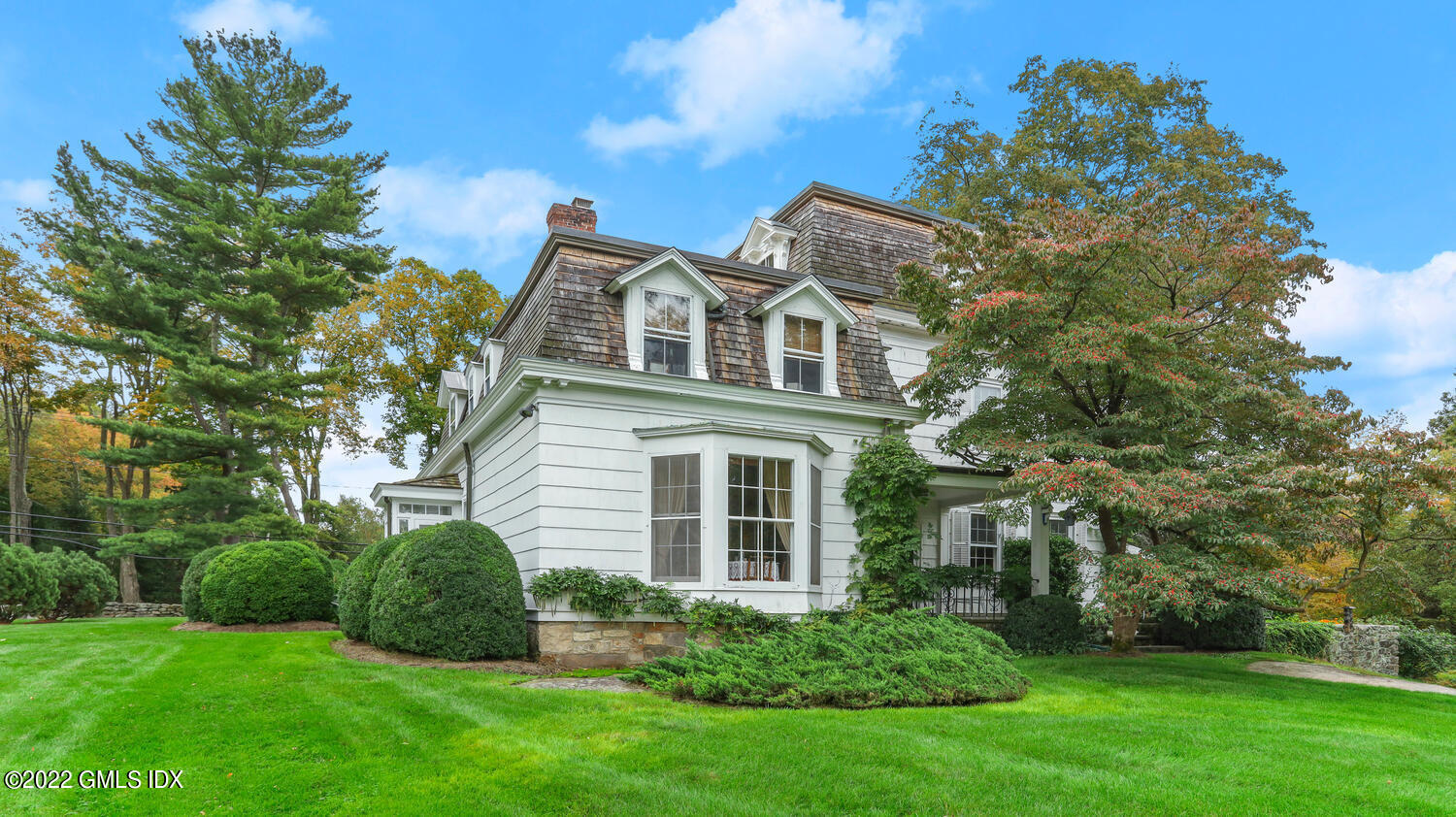 155 Taconic Road Greenwich, CT 06831 - Photo 8 of 26 a front view of a house with a garden
