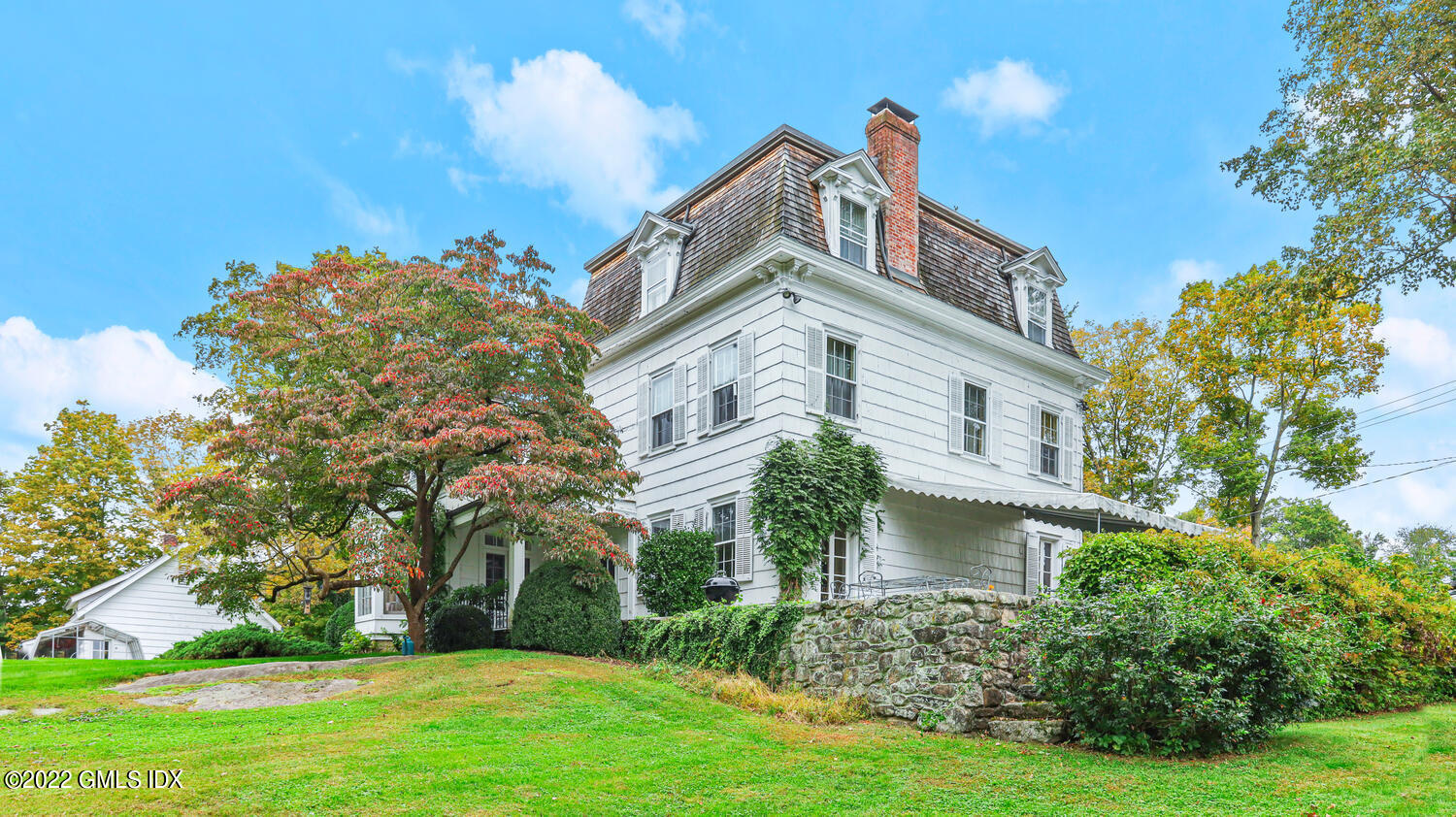 155 Taconic Road Greenwich, CT 06831 - Photo 9 of 26 a front view of a house with a yard