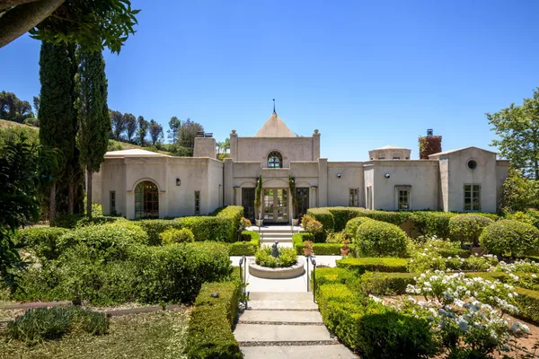 a front view of a house with garden