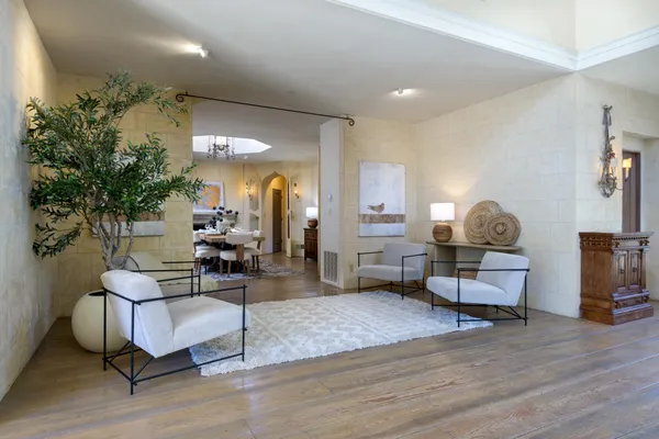 a living room with furniture and a lamp