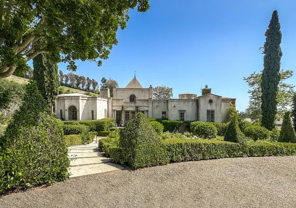 a view of a garden with a building in the background