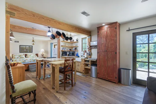 a view of a dining room with furniture and wooden floor