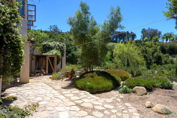 a view of a backyard with sitting area