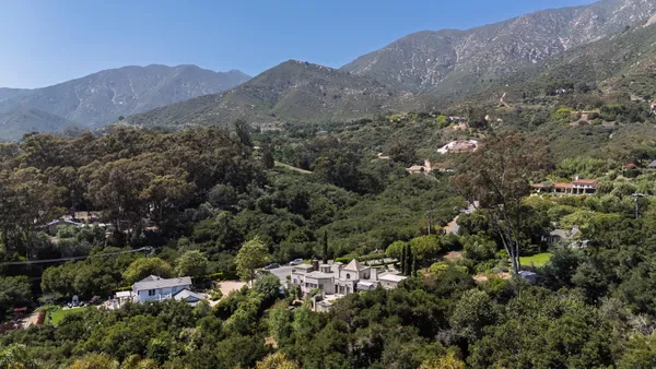 an aerial view of residential house and green space