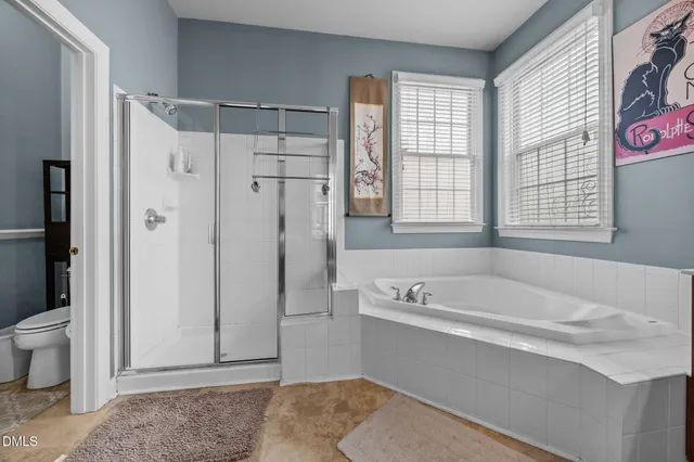 a spacious bathroom with a granite countertop tub shower and sink