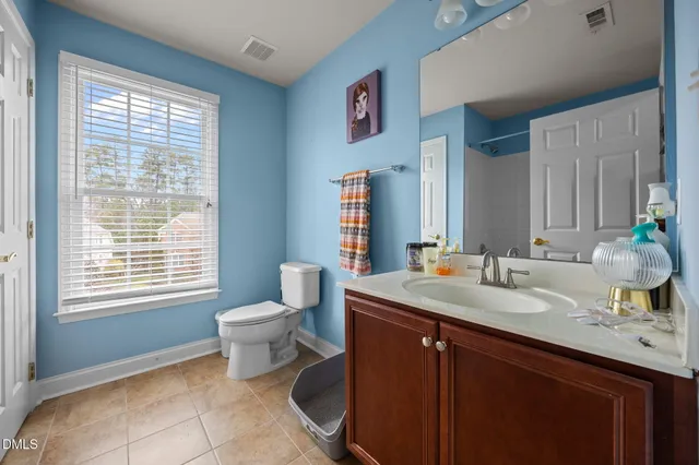 a bathroom with a sink toilet and a mirror