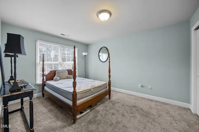 a bedroom with a bed and large window