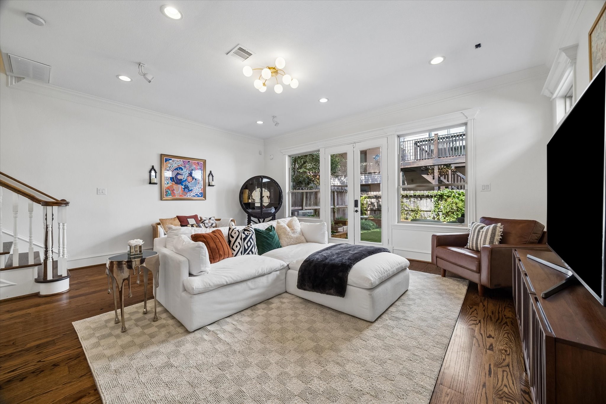 5334 Inker Street Houston, TX 77007 - Photo 7 of 39 This space boasts a refined aesthetic, blending sophisticated craftsmanship with contemporary lighting to create a bright, inviting atmosphere perfect for both relaxation and entertaining.