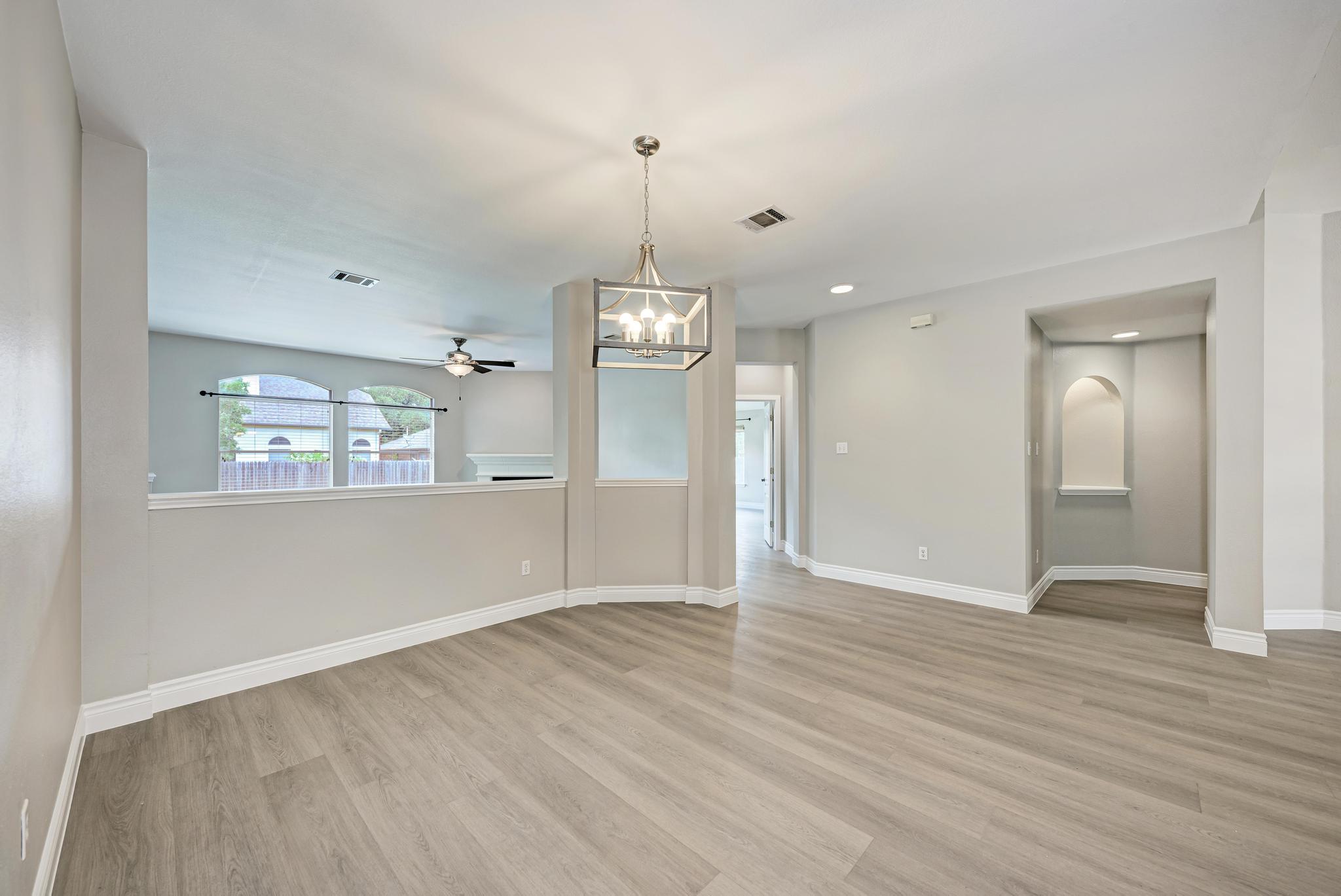 4408 Tello Path Austin, TX 78749 - Photo 7 of 38 Unfurnished room with a chandelier, light wood-style flooring, a ceiling fan, and recessed lighting