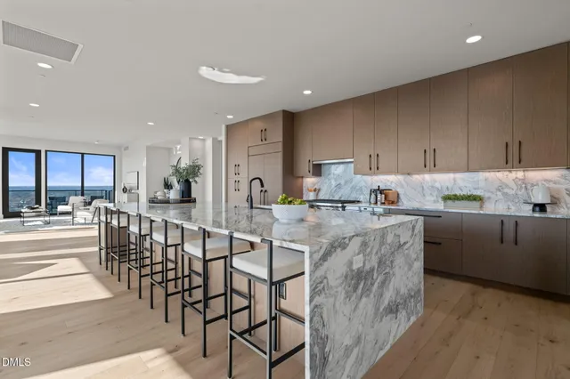 a large kitchen with granite countertop a large counter top and sink
