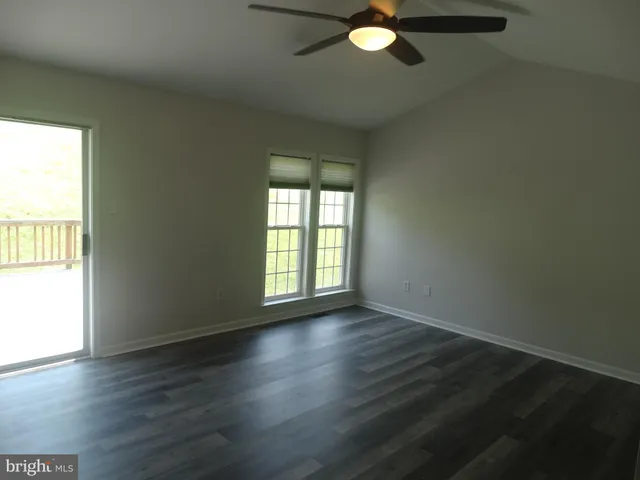 an empty room with wooden floor and closet