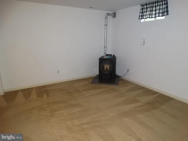 an empty room with furniture and a window