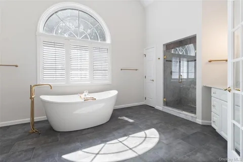a living room with a window and a chandelier