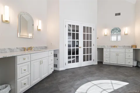 a spacious bathroom with a granite countertop sink mirror and