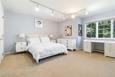 a bedroom with a bed and a desk