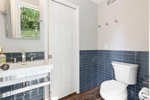 a bathroom with a toilet a sink and a shower
