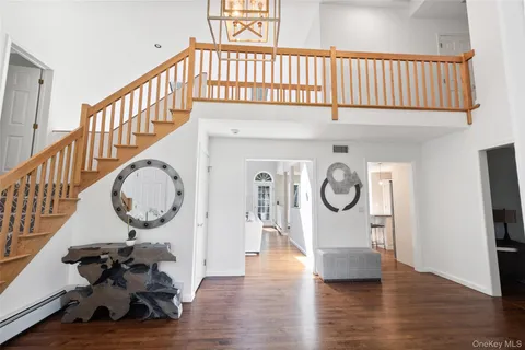 a view of a hallway with wooden floor and entryway
