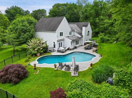 a view of a house with a garden and a swimming pool
