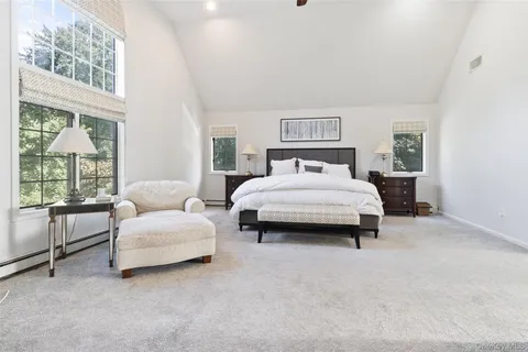 a bedroom with a bed and a large window