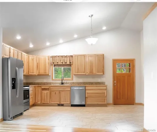 a kitchen with a refrigerator and a sink